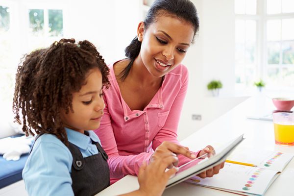 Homeschooling mother and child using online public library resources over a tablet