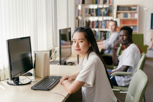 Academic librarian using a computer to assess her students' understanding of library instruction