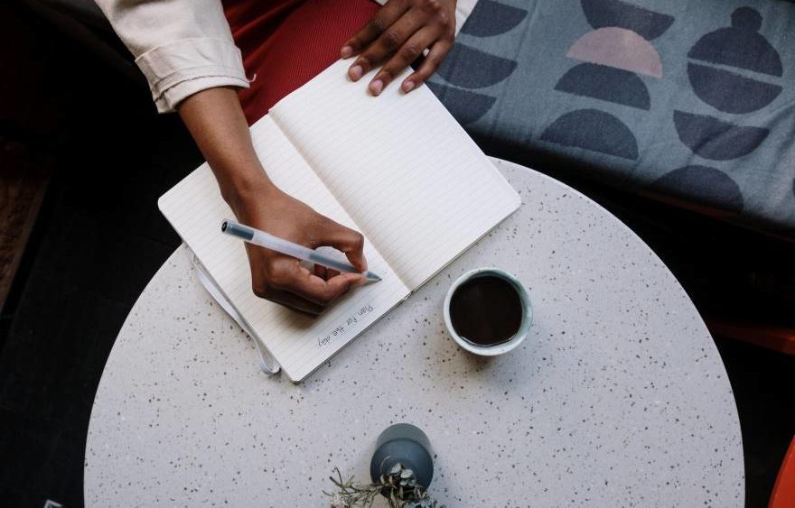 Librarian writing her plan for the day in a notebook