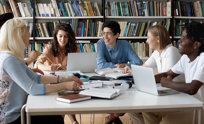 Cheerful librarians conducting a diversity audit