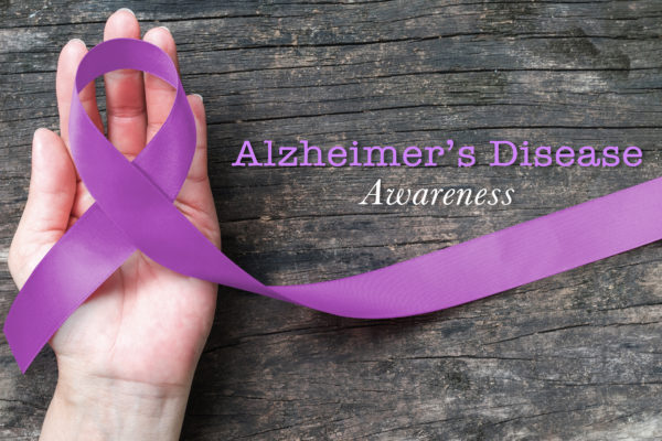 hand with purple ribbon for Alzheimer's disease awareness