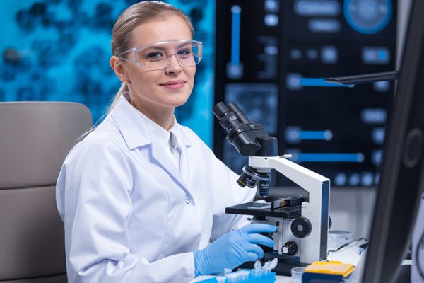 Female STEM researcher at a microscope