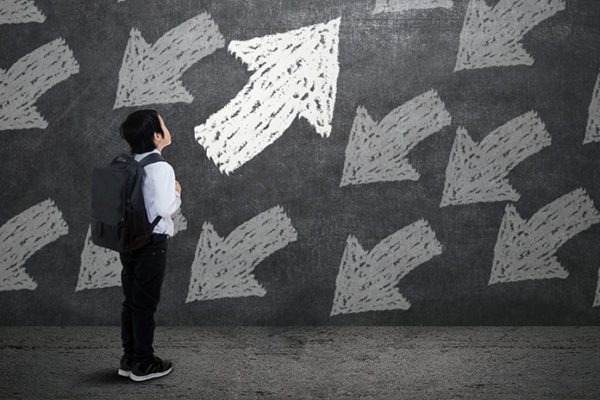 Elementary school student surrounded by arrows representing decisions