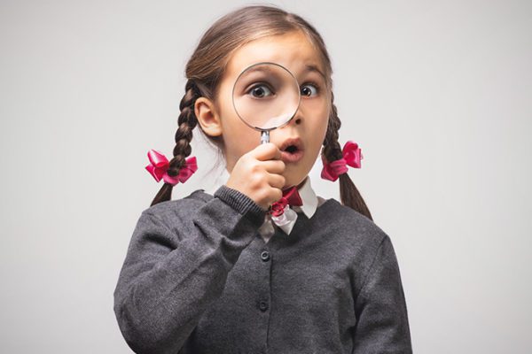 Elementary school girl with magnifying glass