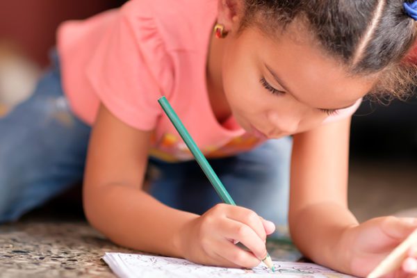 Little girl writing in journal