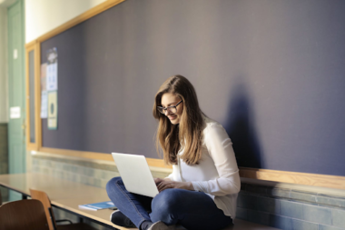 High school student on laptop in classroom